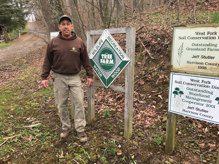 Jeffrey with his Tree Farm sign