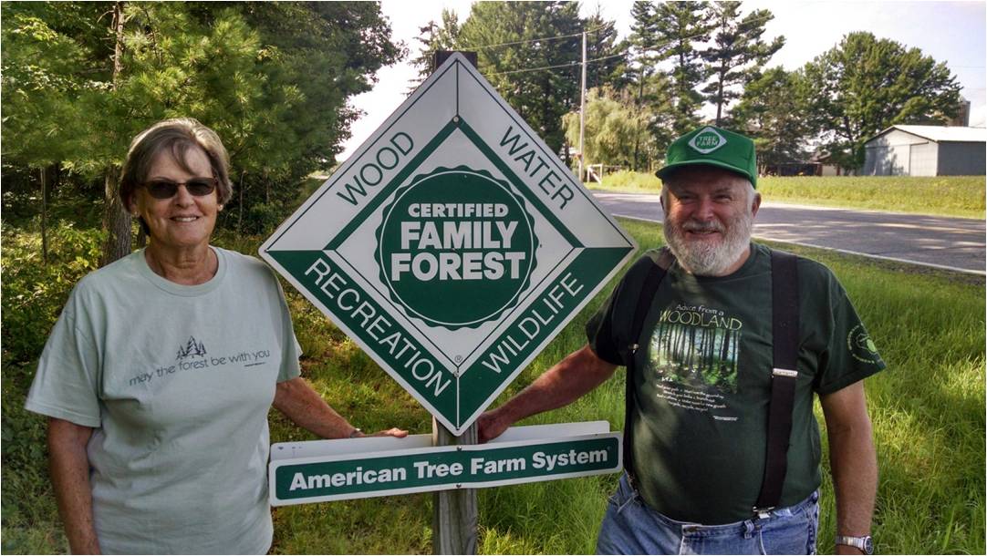 The Czaja family in front of their Tree Farm sign