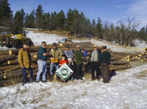 Family with their Tree Farm sign